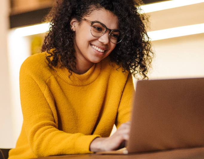 woman sitting down and using a laptop